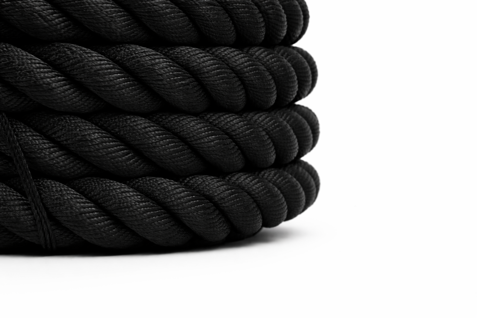 Coiled black rope on a white background
